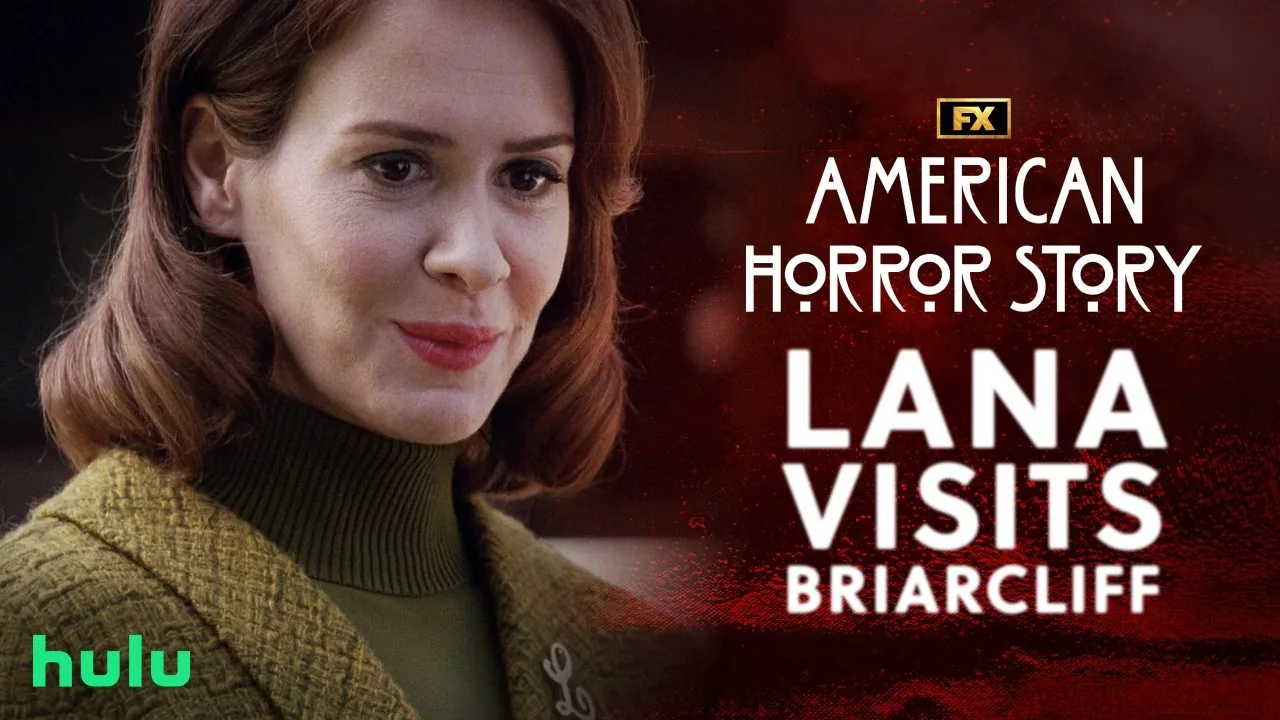 Sarah Paulson as Lana Winters stands beside the FX American Horror Story: Asylum video title Lana Visits Briarcliff.