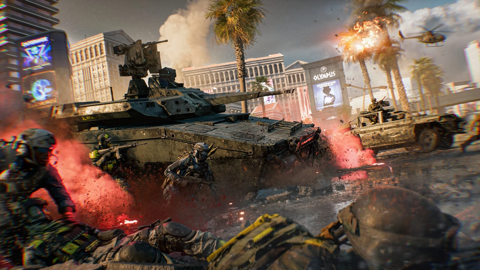 Soldiers advance beside a tank and armored vehicle through a damaged Vegas street, with explosions among palm trees and a helicopter overhead.