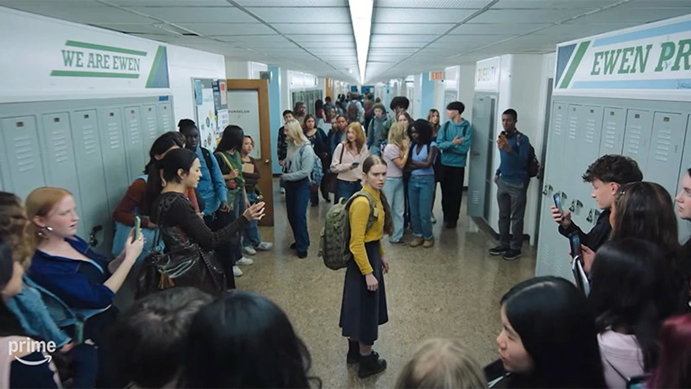 Carrie White standing alone in a crowded high school hallway as classmates film her on their phones, from the Carrie 2026 Prime Video trailer.