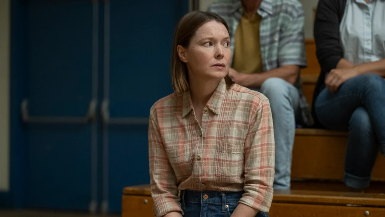 Samantha Sloyan as Margaret White sitting on gymnasium bleachers in Prime Video's Carrie.