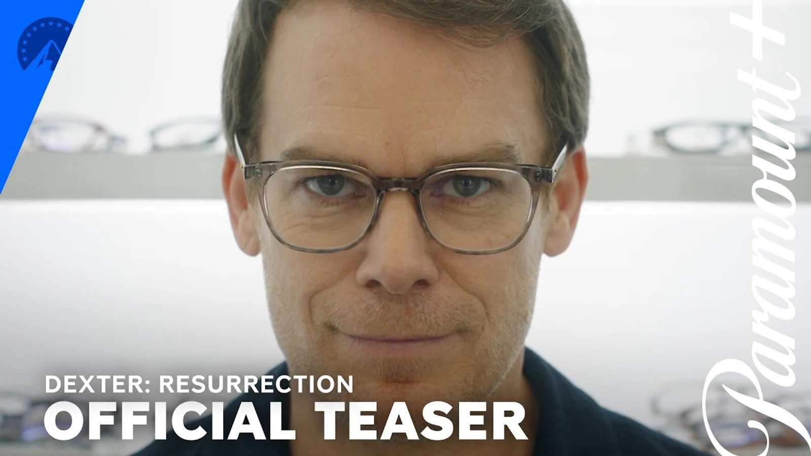 Official Paramount+ teaser still of Michael C. Hall as Dexter Morgan wearing new glasses at an optometrist's office, with the Dexter: Resurrection Official Teaser title card.