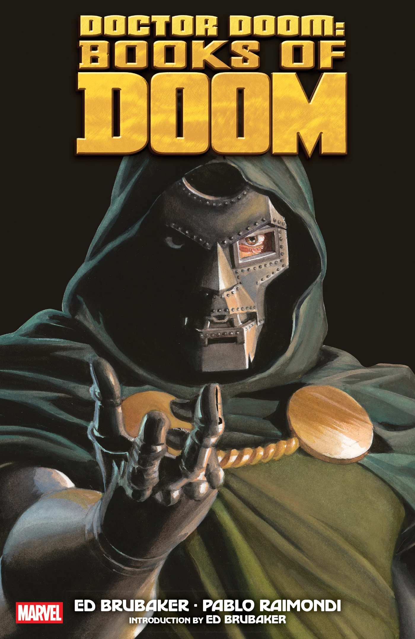 Doctor Doom in his metal mask and green hood reaches forward on Alex Ross's cover for the 2025 Books of Doom paperback.