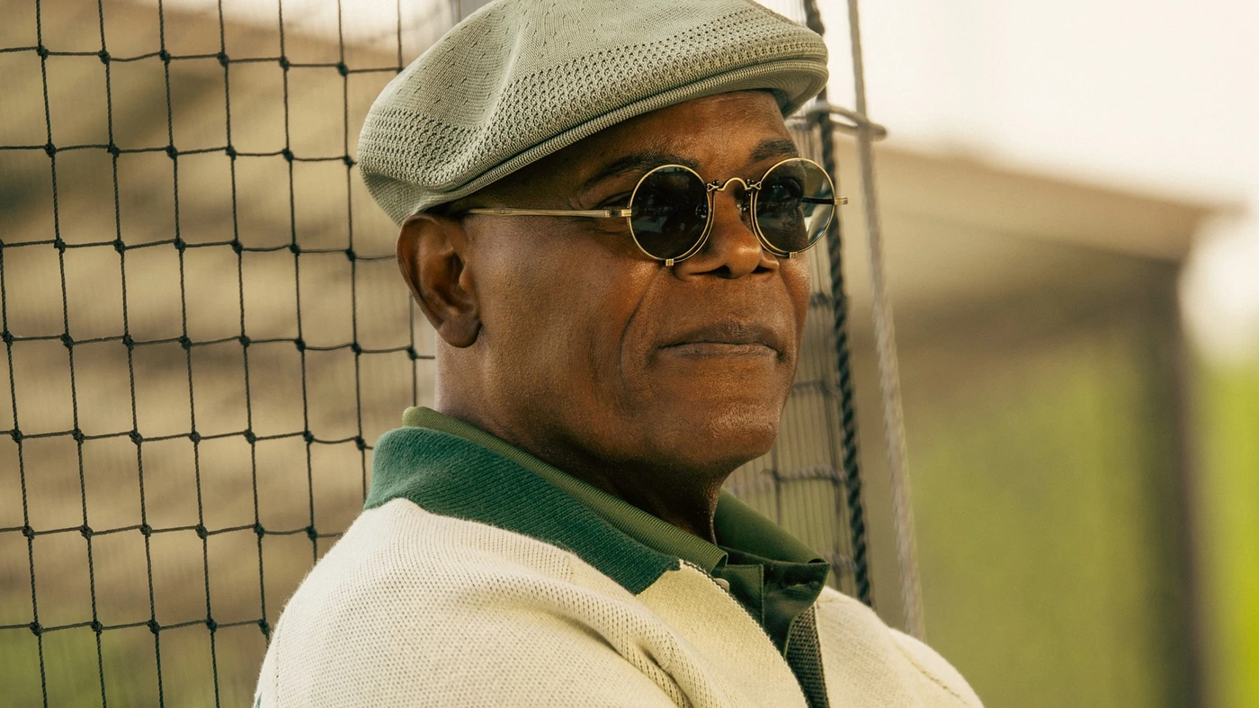 Samuel L. Jackson as Russell Lee Washington Jr., wearing a flat cap and round sunglasses, in an official Frisco King production still.