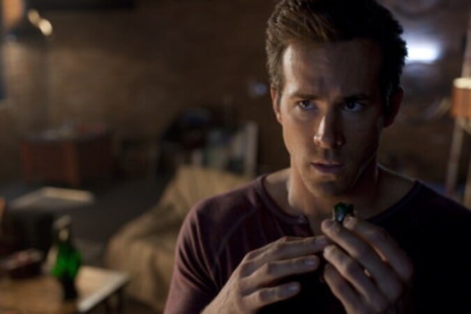 Ryan Reynolds as Hal Jordan holding the Green Lantern power ring in Green Lantern (2011).