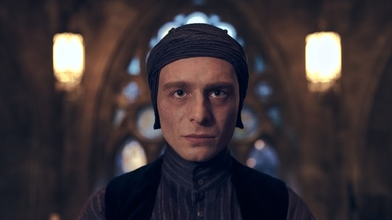 Luke Thallon as Professor Quirinus Quirrell wearing his turban in a Hogwarts hallway, from HBO's official September 2026 Harry Potter Philosopher's Stone press materials.