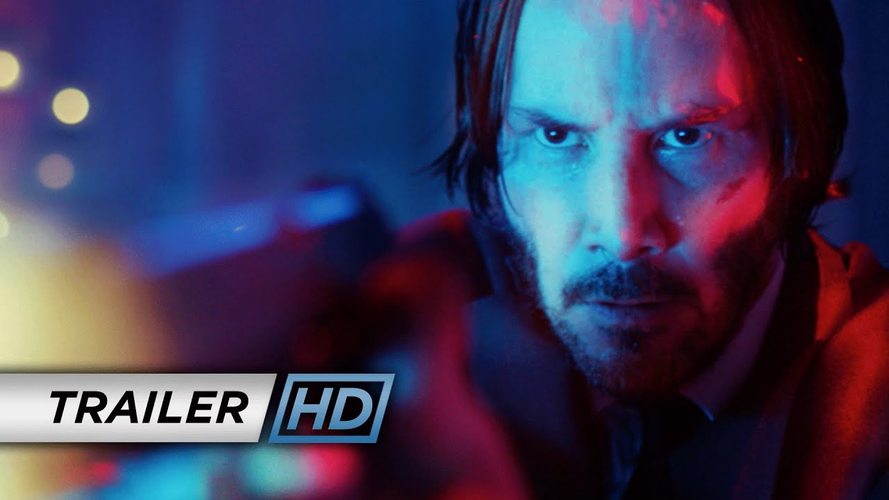 Keanu Reeves as John Wick in a blue-lit frame from Lionsgate's official 2014 trailer.
