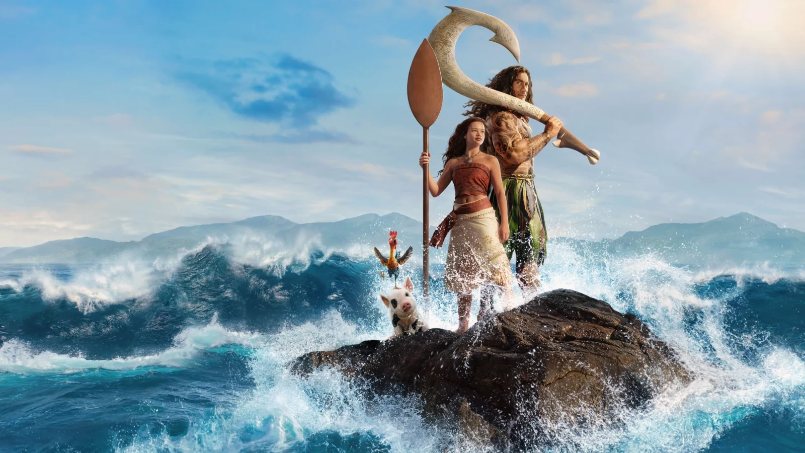 Catherine Lagaʻaia as Moana and Dwayne Johnson as Maui stand amid ocean waves with Heihei and Pua in official live-action Moana artwork.