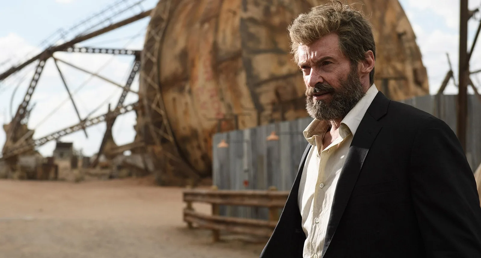 Hugh Jackman as Logan in an abandoned area in a still from the film.