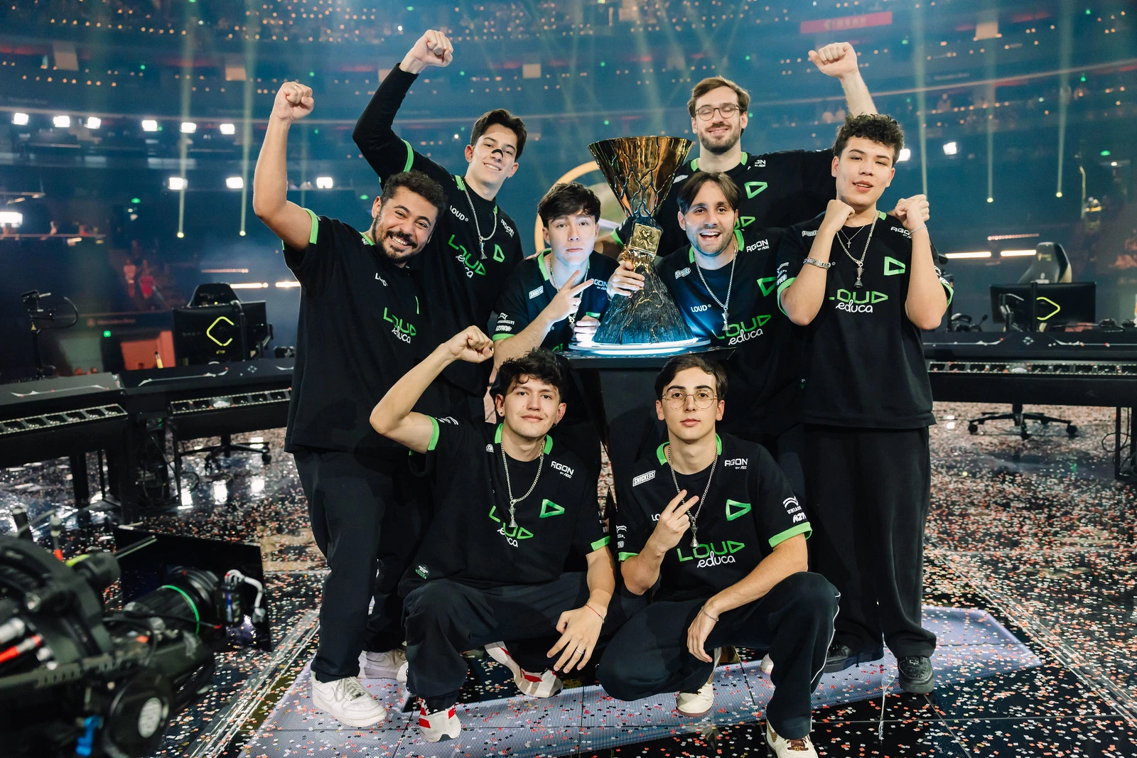 LOUD players and staff pose around the Champions trophy on the confetti-covered Shanghai stage after their October 18 victory.