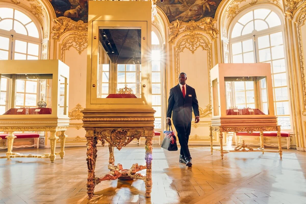 Omar Sy as Assane Diop walking through a gilded Parisian museum gallery in a first-look image from Lupin Part 4.