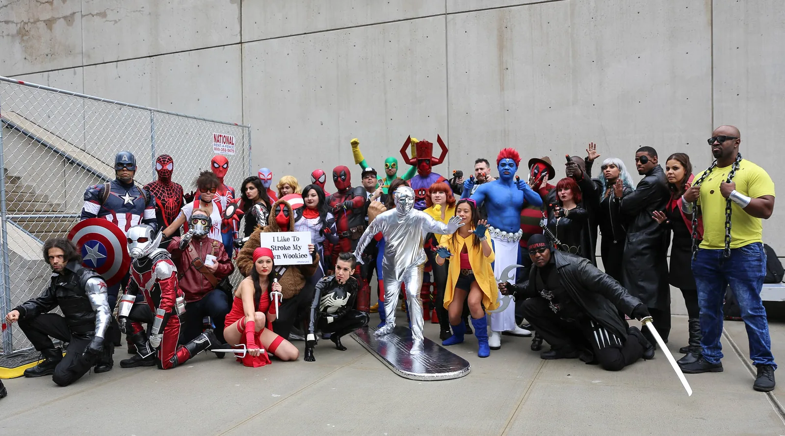 Cosplayers dressed as Marvel characters posing together at New York Comic Con in 2016.