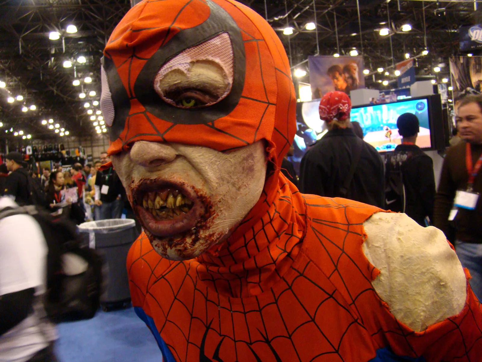 A convention attendee in a damaged Spider-Man costume with zombie makeup at NYCC in 2009.