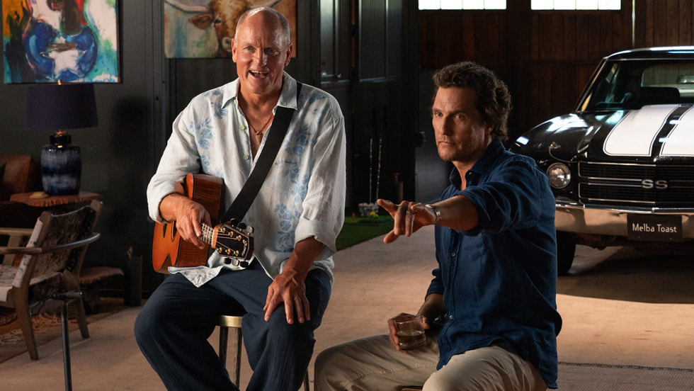 Woody Harrelson holding a guitar beside Matthew McConaughey in an official still from Apple TV's Brothers.