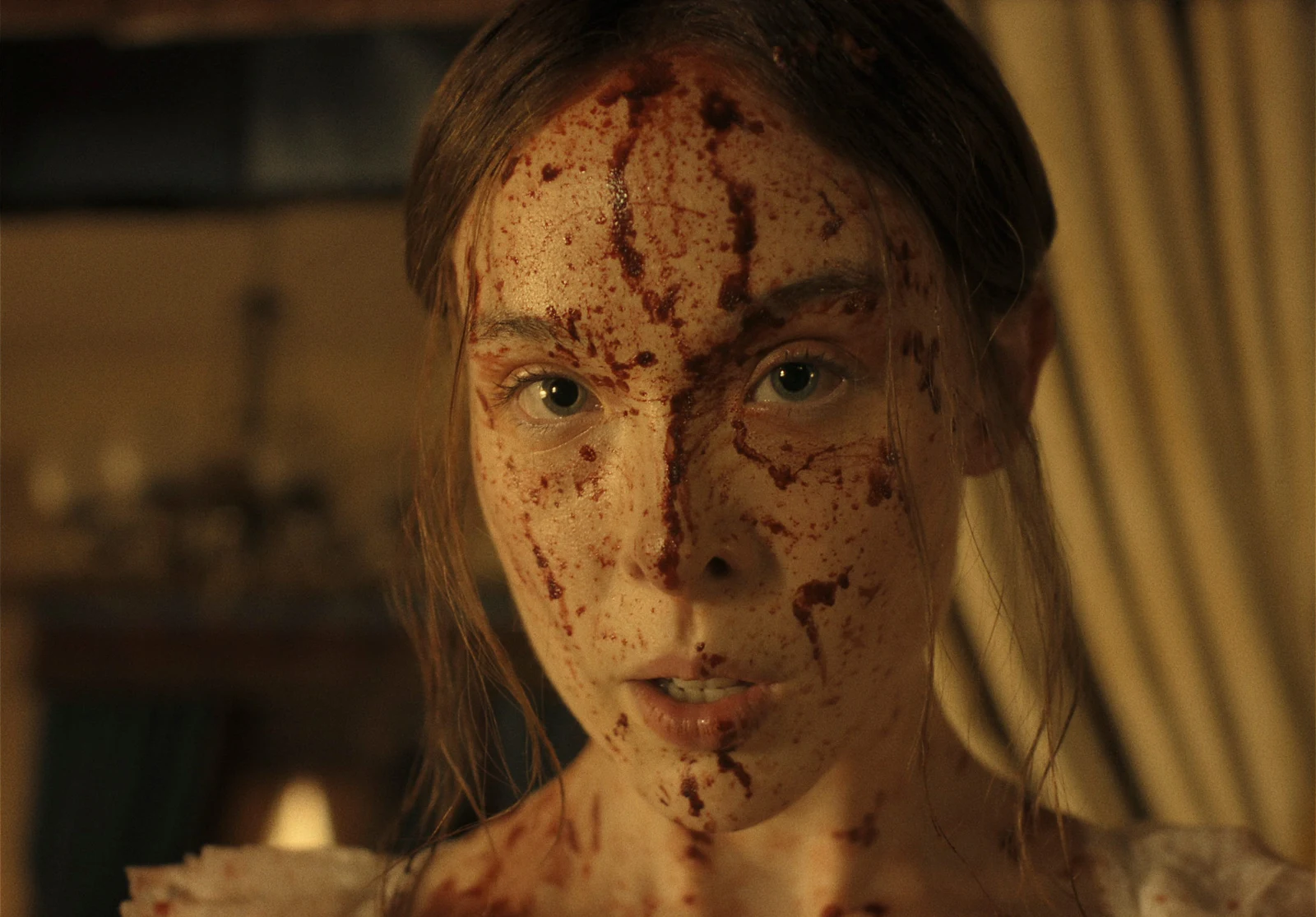 Ella Beatty as Lizzie Borden, blood-spattered, in a still from Netflix's Monster: The Lizzie Borden Story.