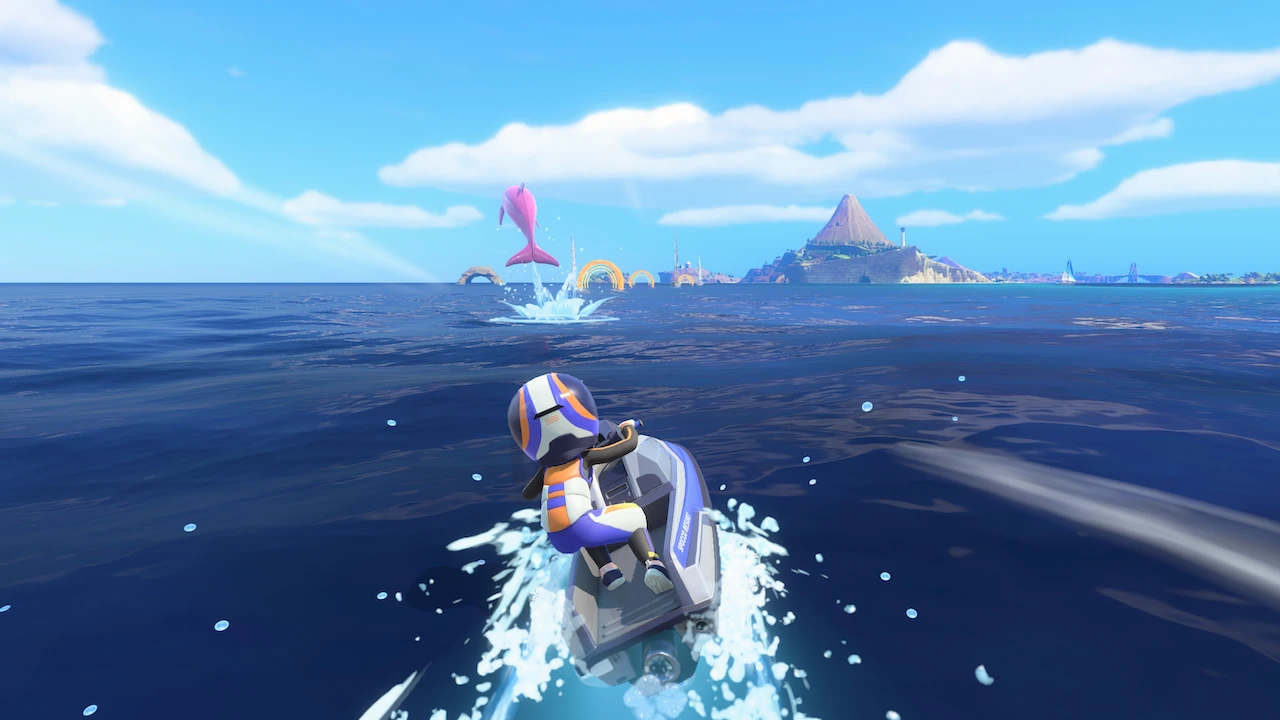 A Sportsmate follows a jumping dolphin on a Power Cruiser, with Wuhu Island in the distance, in Nintendo Switch Sports Resort.