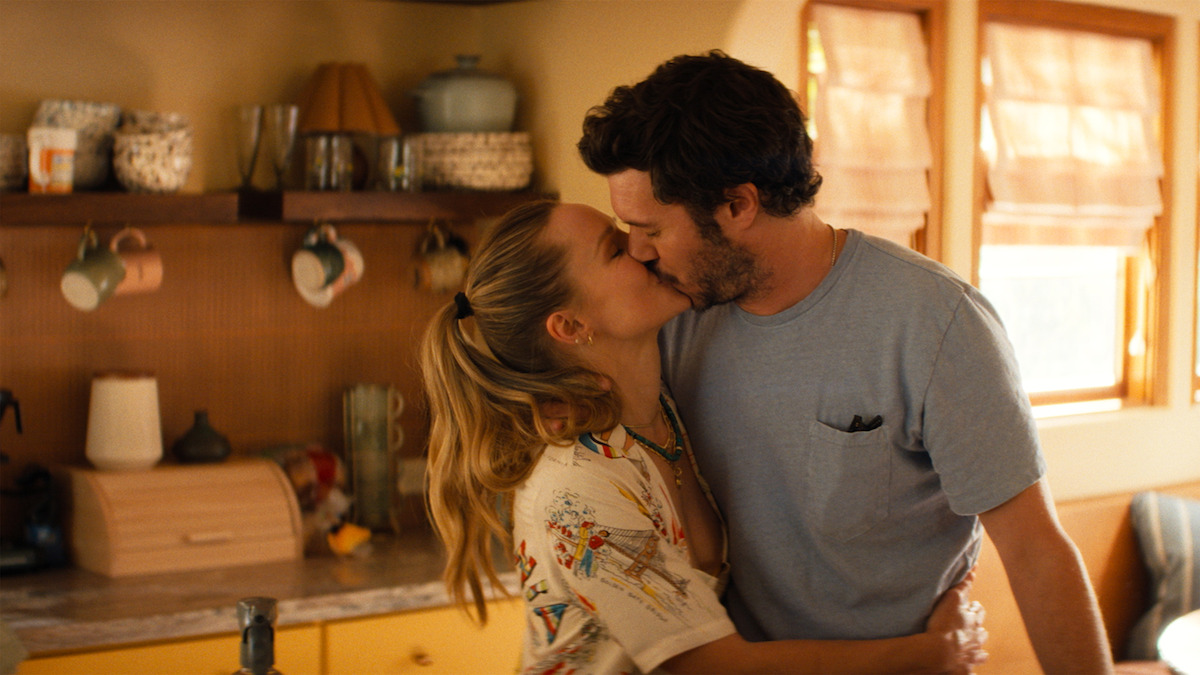 Joanne and Noah kiss in a sunlit kitchen in Netflix's official Nobody Wants This Season 3 image.