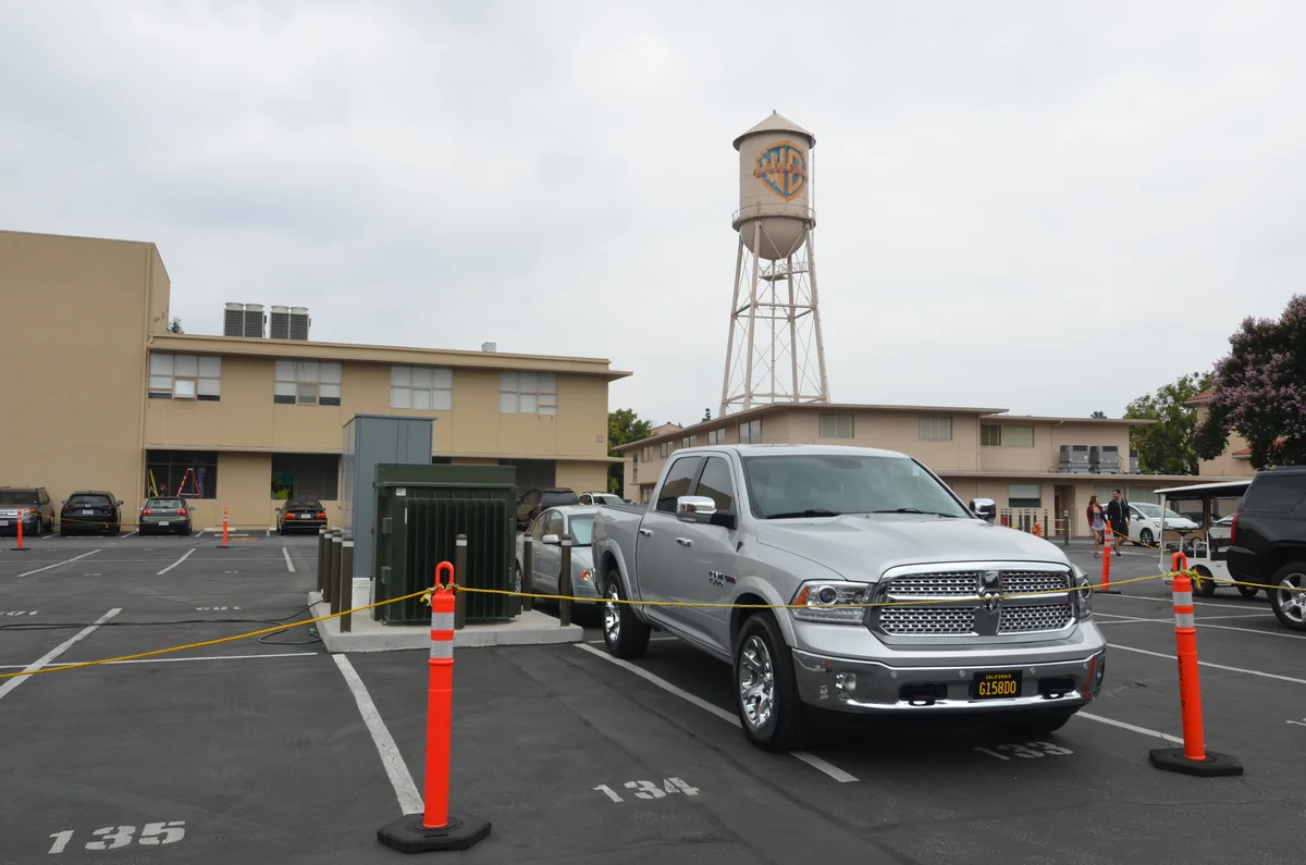 The Warner Bros. water tower above studio buildings and parked vehicles in Burbank, California.