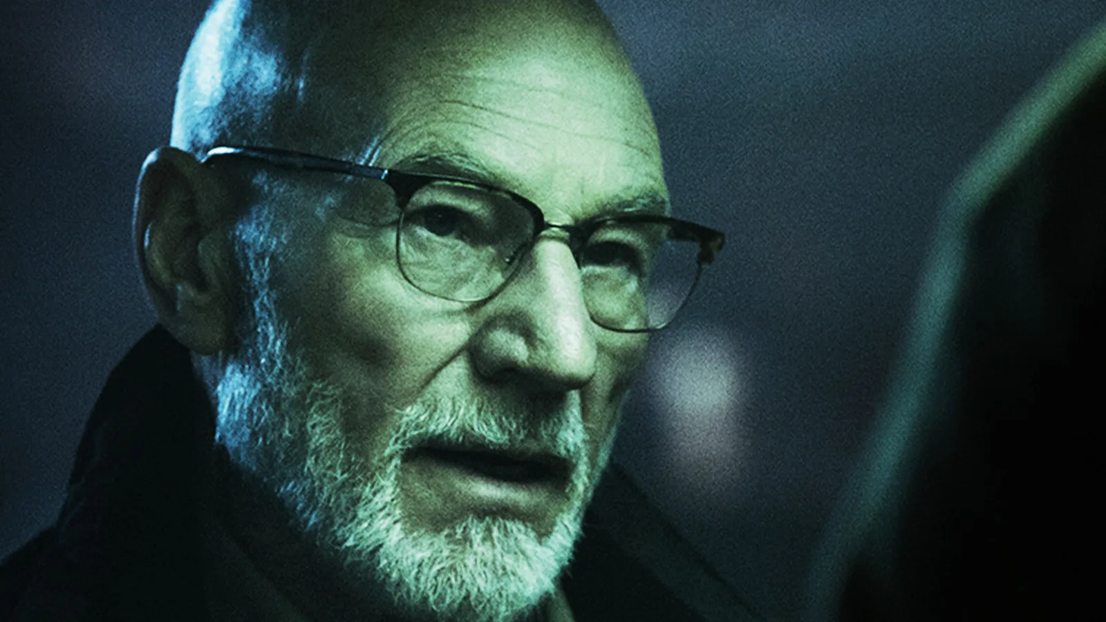 Close-up of Patrick Stewart as Darcy Banker in a green-tinted promotional frame from Green Room.