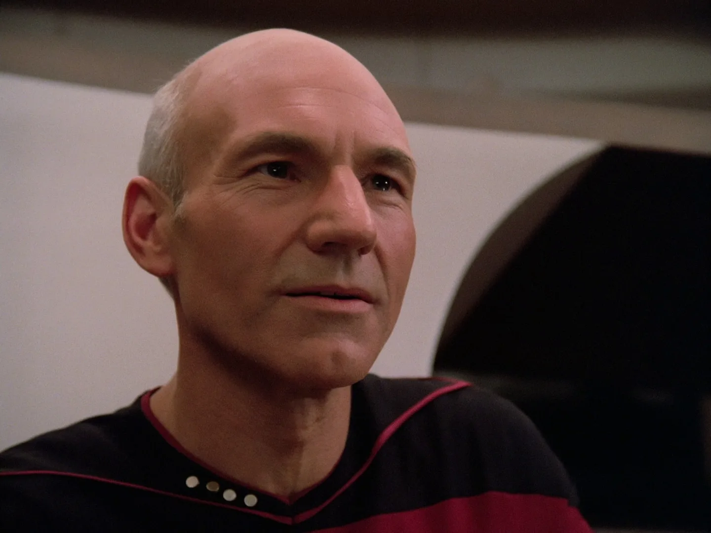 Close-up of Patrick Stewart as Captain Jean-Luc Picard looking toward the viewscreen at the end of the Star Trek: The Next Generation pilot.