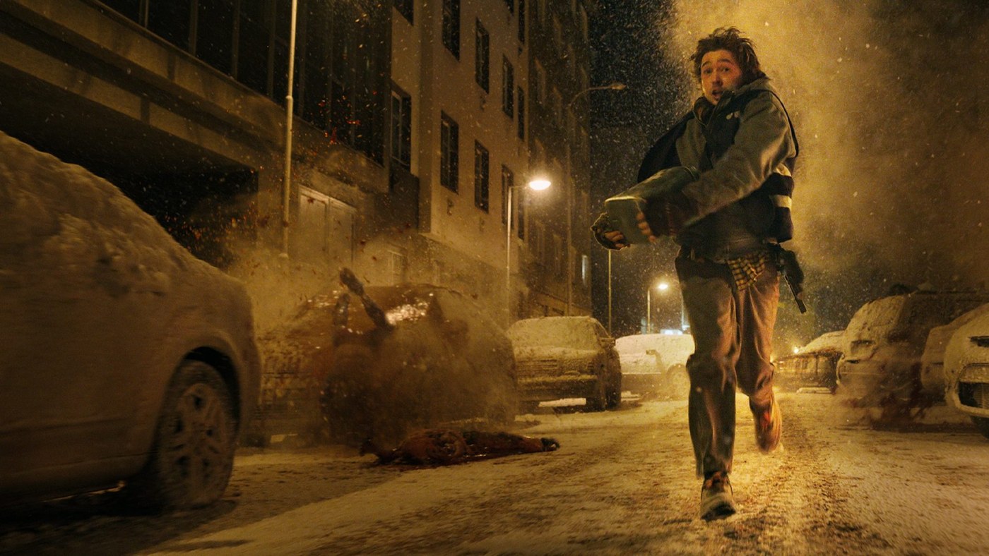 Austin Abrams as Bryan running through a snowy Raccoon City street in Zach Cregger's Resident Evil (2026).
