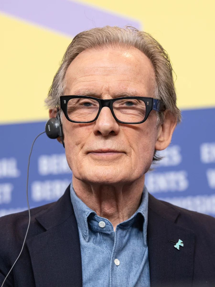 Bill Nighy wearing glasses and a headset at a Berlinale press conference in February 2020.