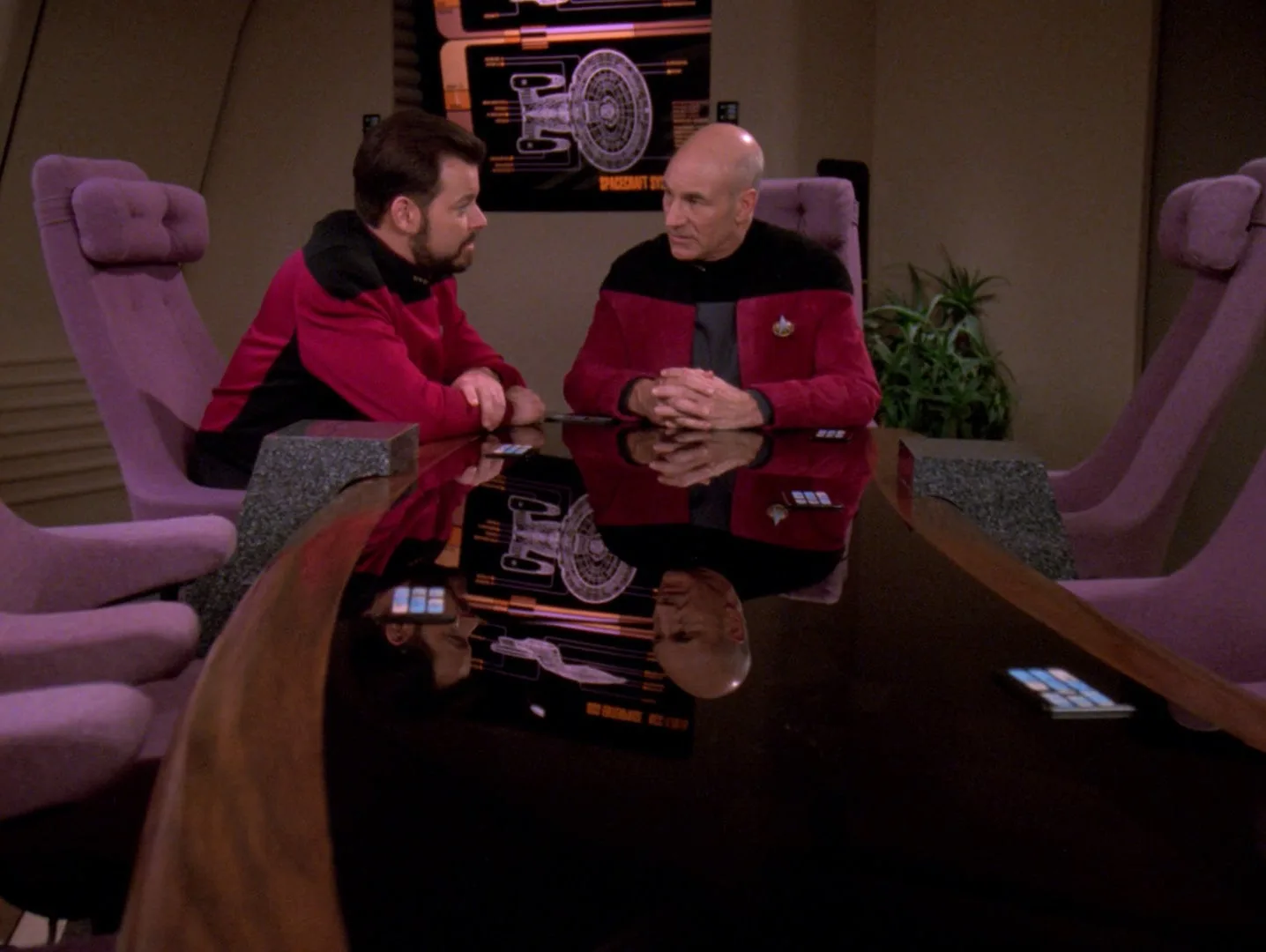 Picard and Riker sit across from each other at a table in the observation lounge in the final scene of Tapestry.