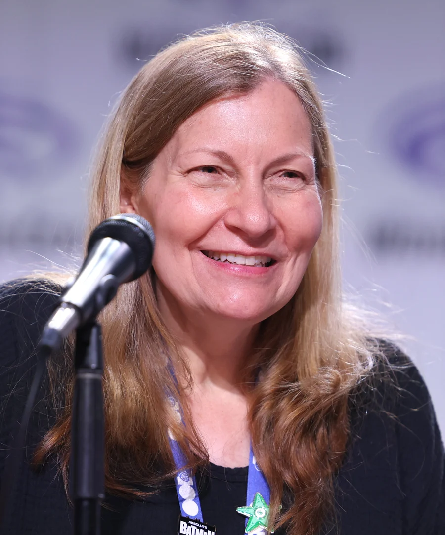 DC editor-in-chief Marie Javins speaking into a microphone in an archival March 2025 event photograph.
