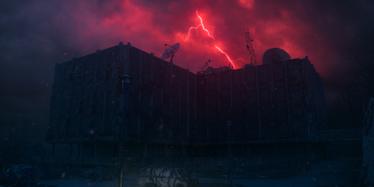 Hawkins Lab surrounded by red lightning inside the Upside Down in Stranger Things 5