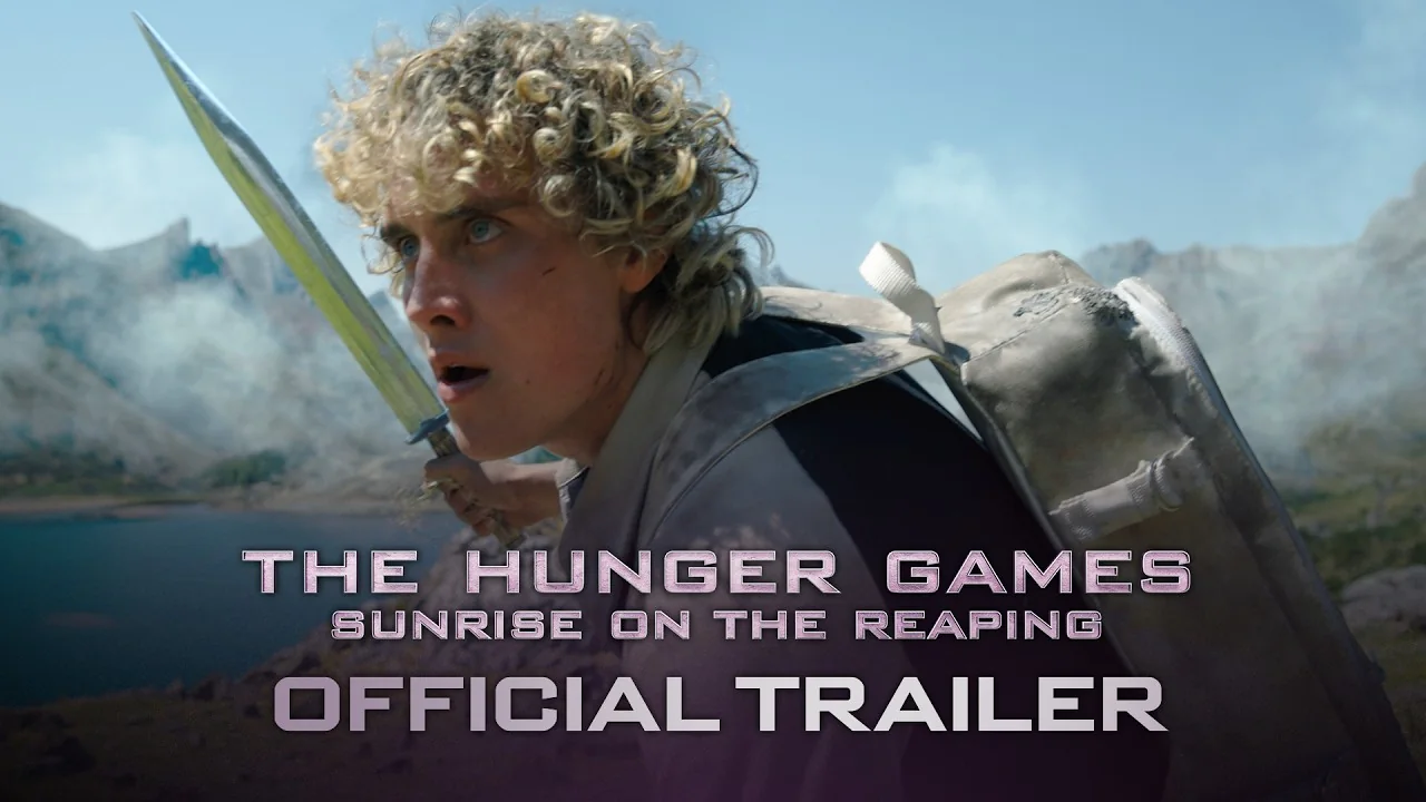 Joseph Zada as a young Haymitch Abernathy holding a blade in a mountain arena, with The Hunger Games: Sunrise on the Reaping title and the words Official Trailer, from Lionsgate's trailer thumbnail.