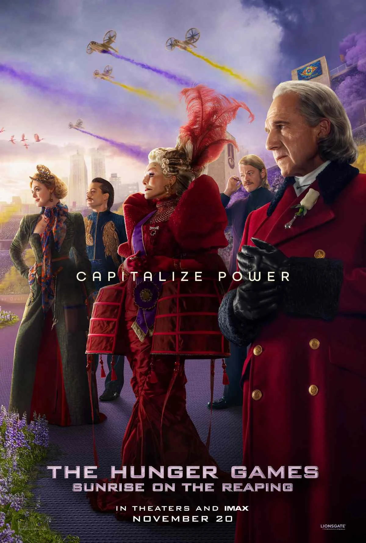 Official Sunrise on the Reaping poster featuring Ralph Fiennes as President Snow and Capitol officials, with the tagline Capitalize Power.