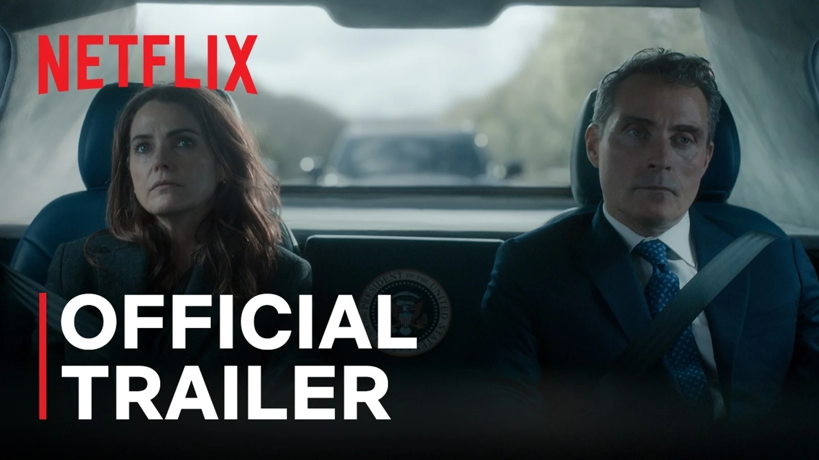 Official Netflix trailer still of Kate Wyler and Hal Wyler riding in a motorcade vehicle with a presidential seal visible between them.