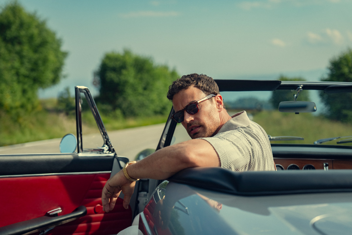 Theo James as Eddie Horniman beside a convertible in The Gentlemen Season 2.
