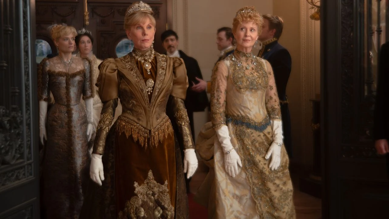 Women in ornate gowns and tiaras arrive at a reception in HBO’s official The Gilded Age Season 4 press image.