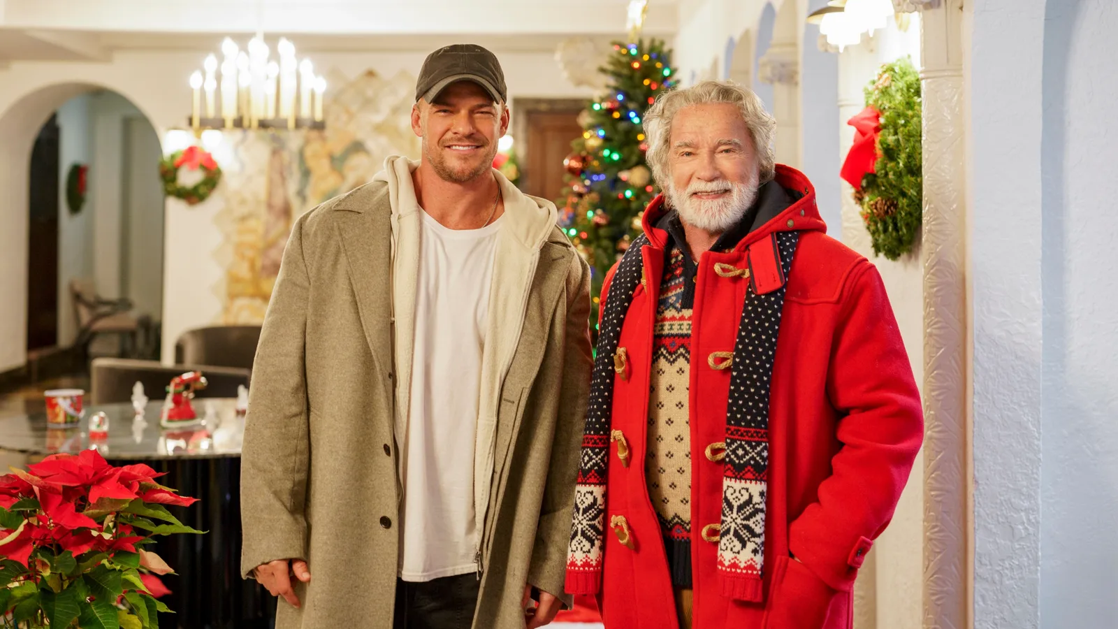 Alan Ritchson and Arnold Schwarzenegger, dressed as Santa, stand together in an official still from The Man with the Bag.