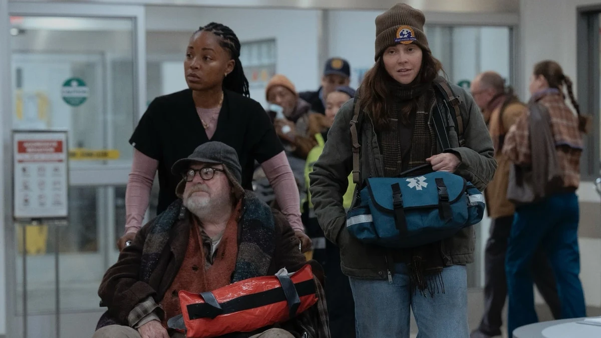 ER staff bringing in patients through the hospital entrance in an official first-look image for The Pitt Season 3.