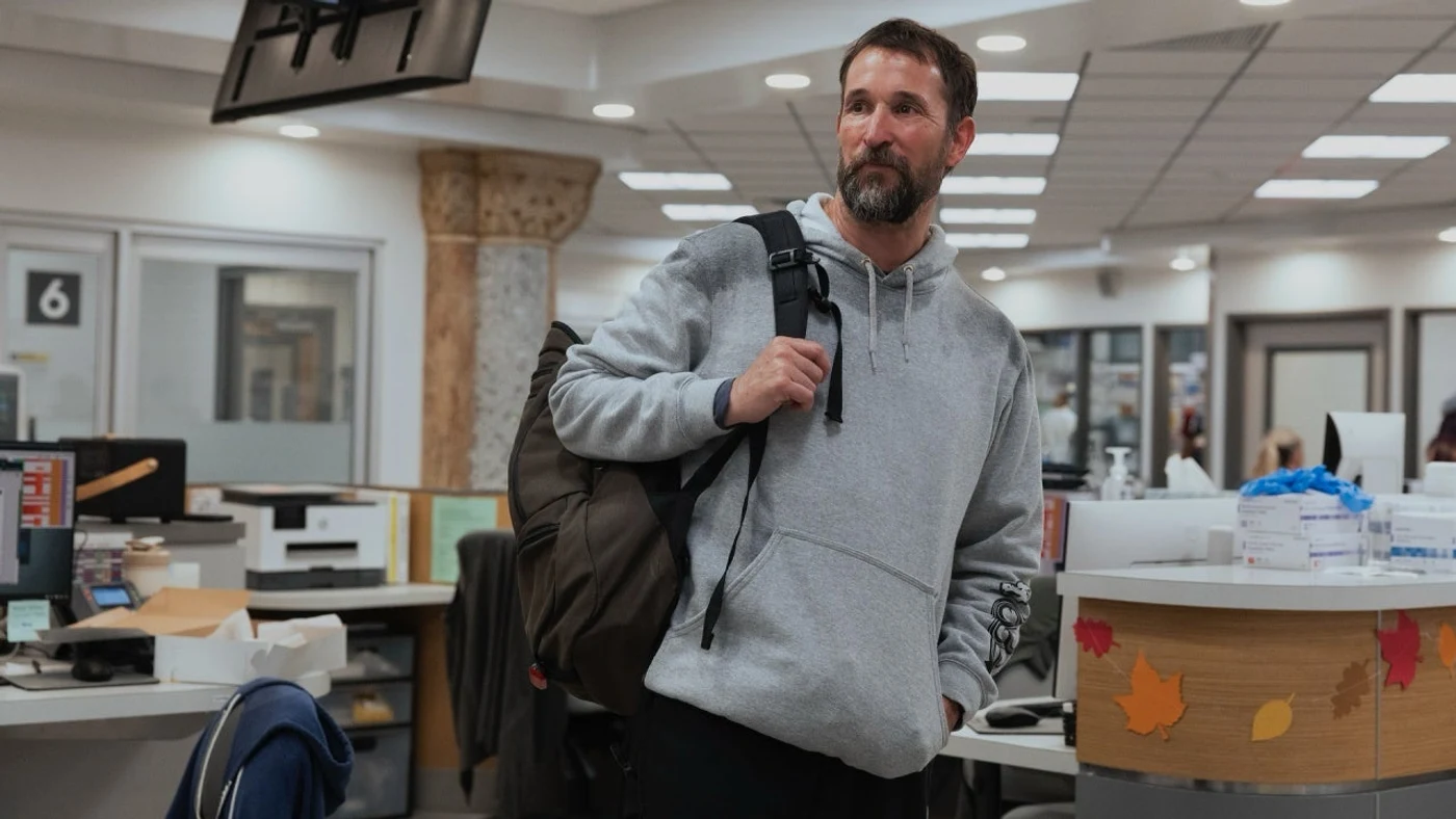 Noah Wyle as Dr. Robby returning to the hospital with a backpack in an official first-look image for The Pitt Season 3.