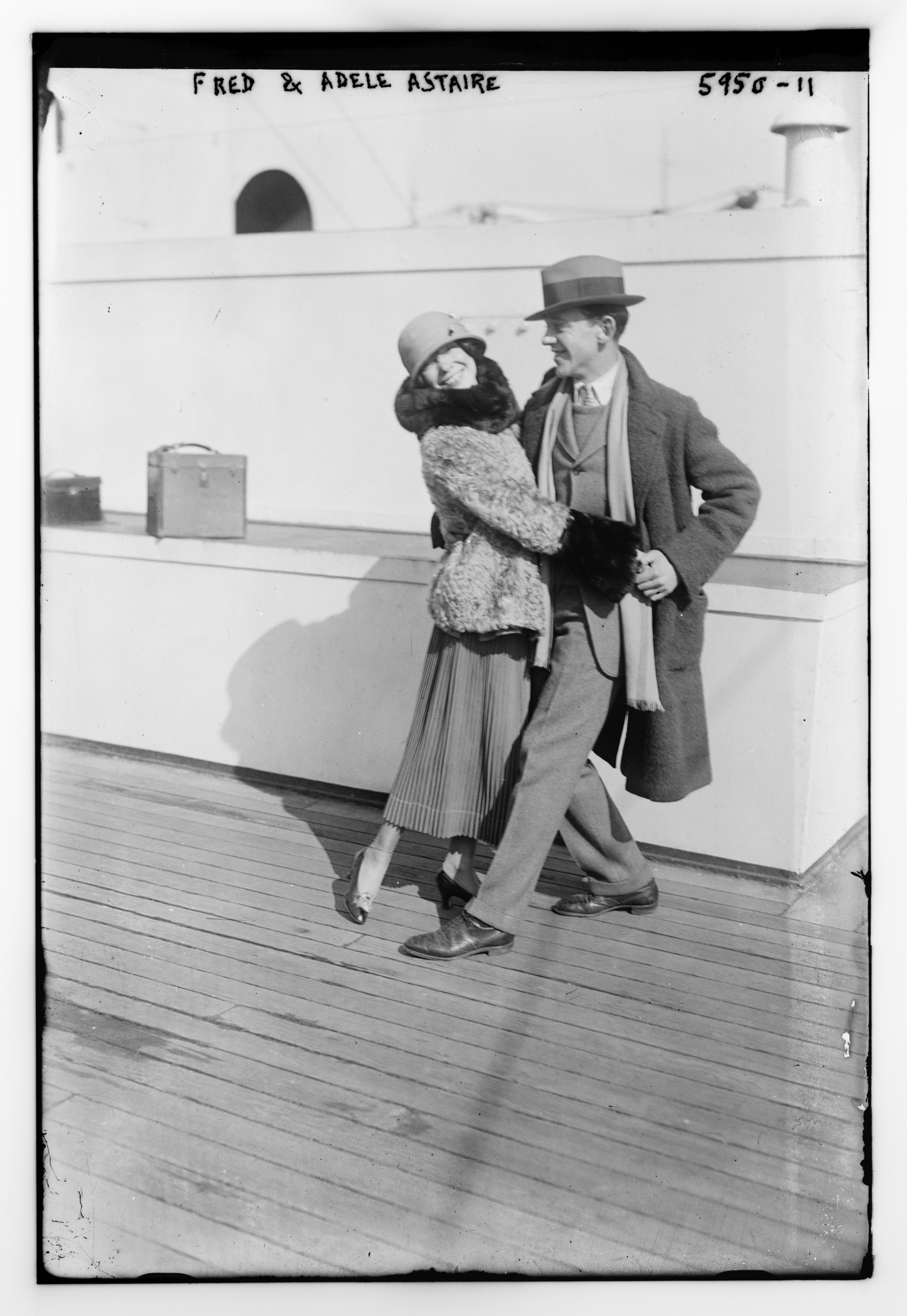 Archival black-and-white photograph of Adele and Fred Astaire walking together.