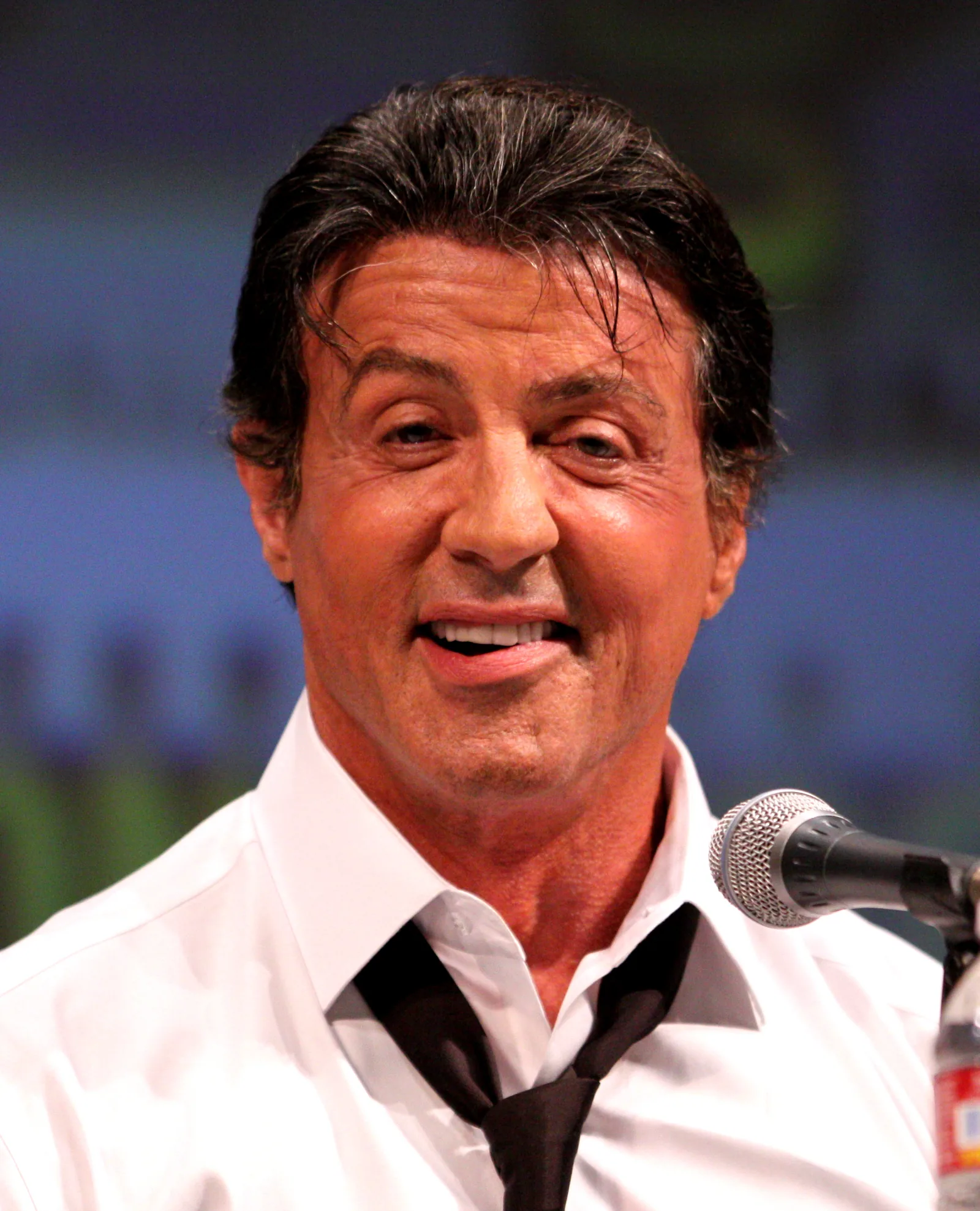 Sylvester Stallone wearing a white shirt and loosened dark tie at San Diego Comic-Con in 2010.