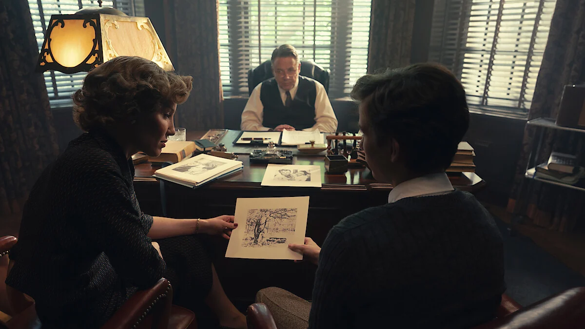 Annabelle Wallis as Christiana Morgan and Jacob Tremblay as Ted Kaczynski sit opposite Russell Crowe as Henry Murray in an office in UNABOMBER.