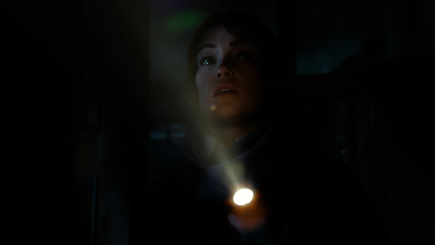 A Dead True crew member shining a flashlight and looking frightened inside Blackwood Sanatorium in the new Until Dawn 2 trailer.